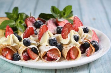 Chef crafting delicious dessert crepes.