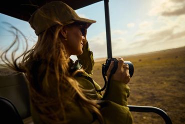 Woman photographing wildlife on safari.