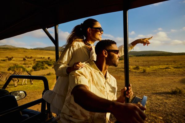 Couple enjoying a safari in the African savannah.