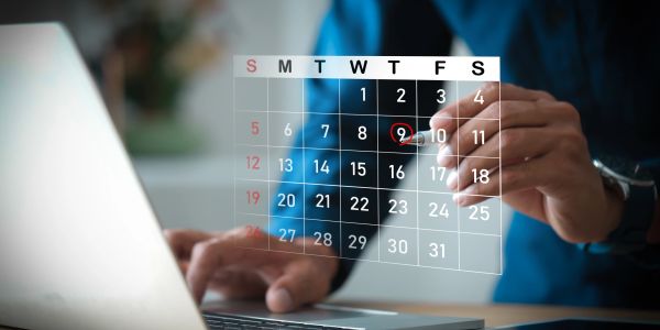 Person marks date on a digital calendar.
