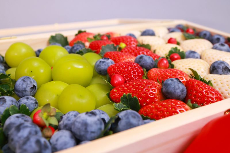 close-up mix variety healthy fruit arranged in wooden box , showcasing vibrant colors premium gift for Happy New year celebration