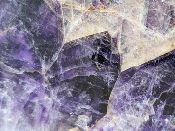Close-up of a purple and white crystalline mineral surface.
