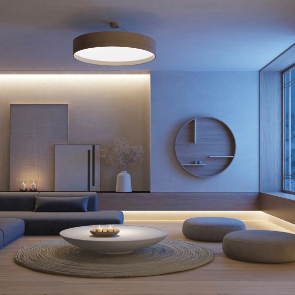 Modern minimalist living room with soft lighting and neutral tones.