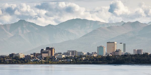 Anchorage cityscape with mountains and river.