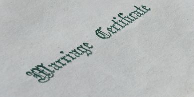 Close-up of 'Marriage Certificate' text on paper.