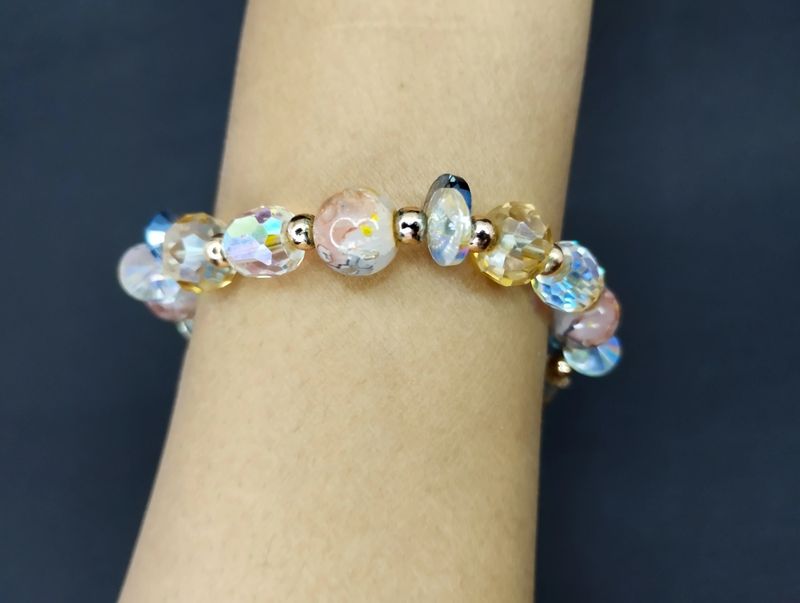 Close-up view of a vibrant beaded bracelet on a human wrist.