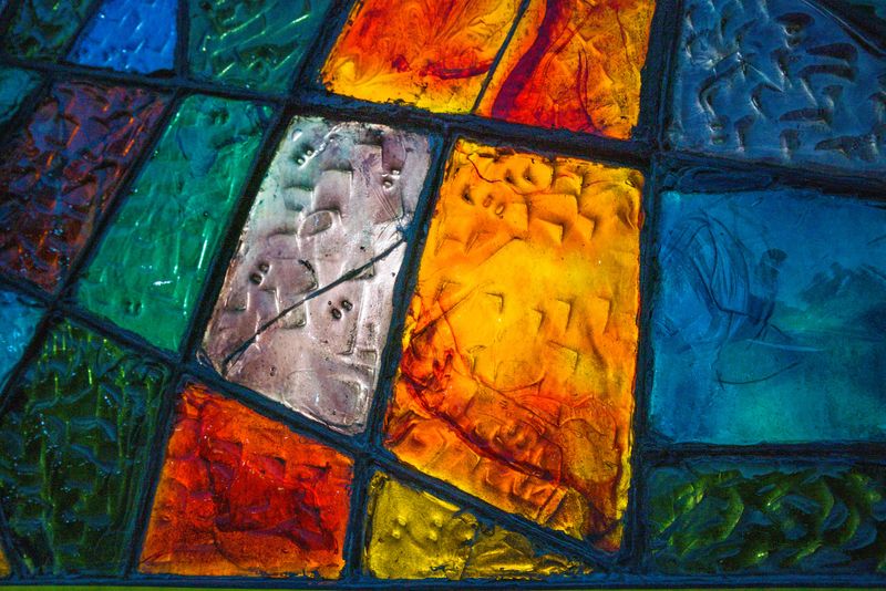 Simple stained glass windows of different colors in Tbilisi, grouped together