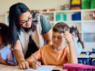 Teacher helping a student with schoolwork.
