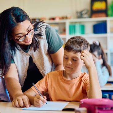 Teacher helping a student with schoolwork.