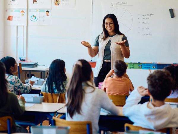 Teacher explaining nutrition to students in classroom.