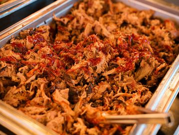 Tray of pulled pork with barbecue sauce.