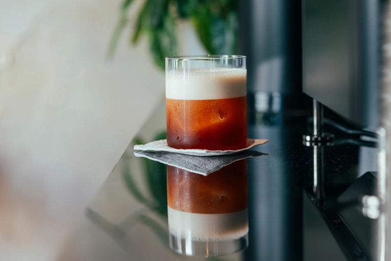 Cold brew fresh coffee is serving with ice and lime zest.