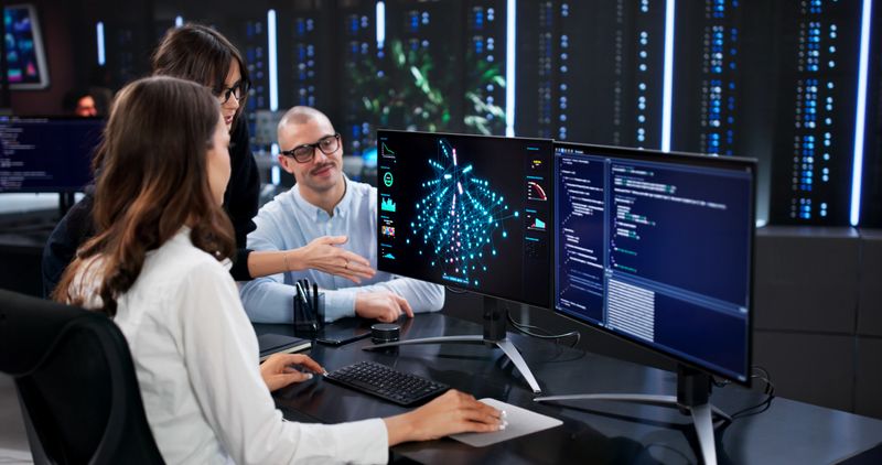 The Cyber Security Team Analyzing Data On Center's Main Screen.