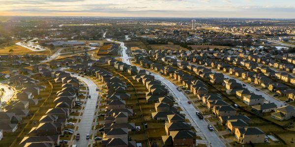 Suburban neighborhood with rows of houses and streets.