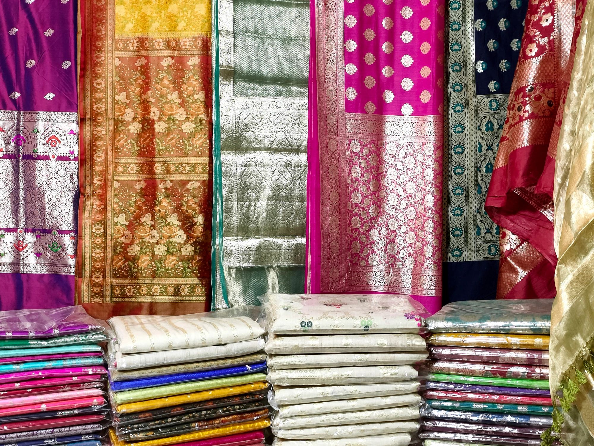Colorful silk sarees displayed in a shop.