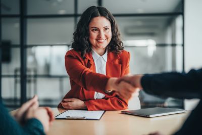 Businesswoman shaking hands during a meeting.