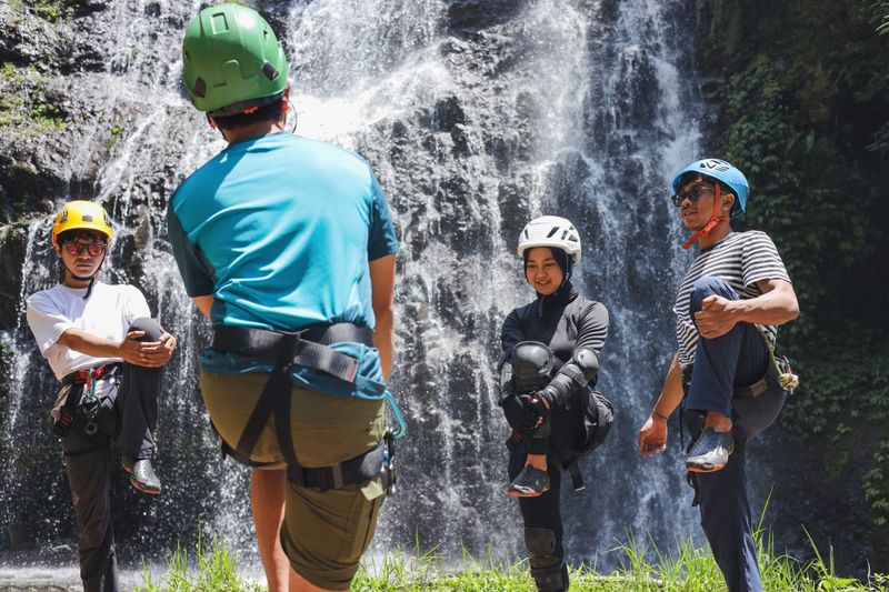 Group of Adventurers Stretching Their Legs Together Before Starting Extreme Sports