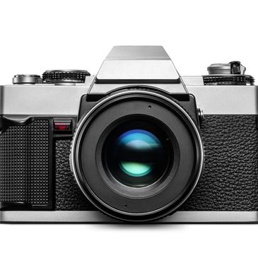 Close-up of a vintage film camera with a large lens.