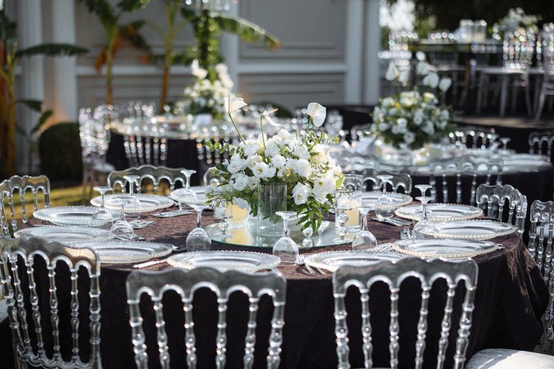 Beautifully decorated table for a wedding event outdoors. Wedding guest setup with fresh flowers in back yard