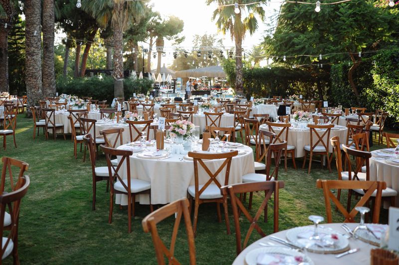 Beautifully decorated table for a wedding event outdoors. Wedding guest setup with fresh flowers in back yard