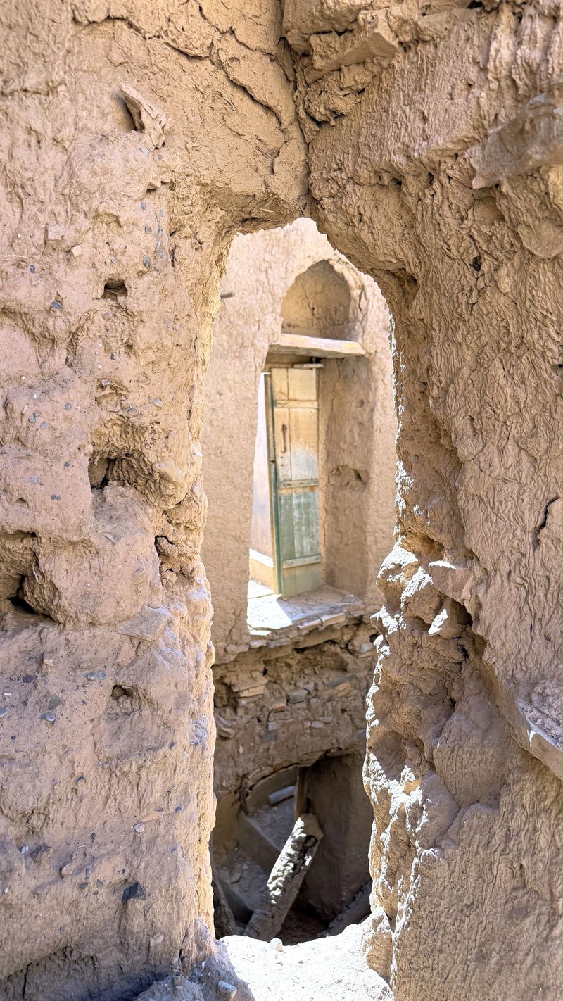 Glimpse Through Ruins, Archaeologist Observes Layered Debris, Framed View Of Rubble And Dust Within Ancient Site, Narrow Opening Showing Complex Layers Of Destruction Illuminated By Warm Light