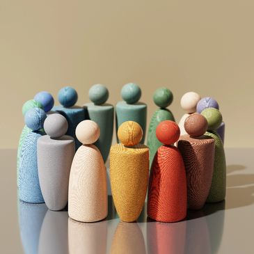 Colorful wooden peg dolls arranged in a circle.