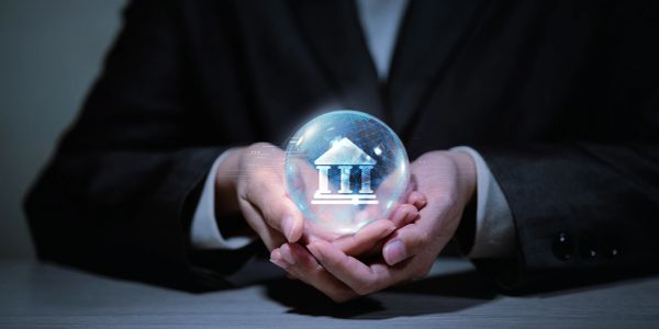 Person holding a glowing sphere with a bank symbol.