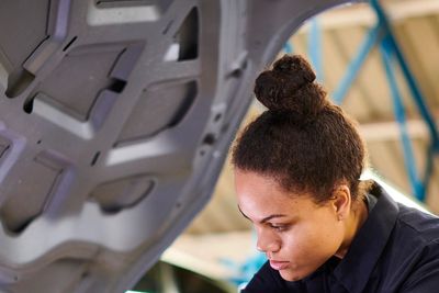 Auto technician repairing engine