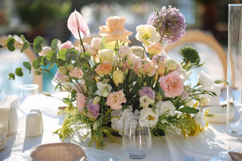 Beautifully decorated table for a wedding event outdoors. Wedding guest setup with fresh flowers in back yard
