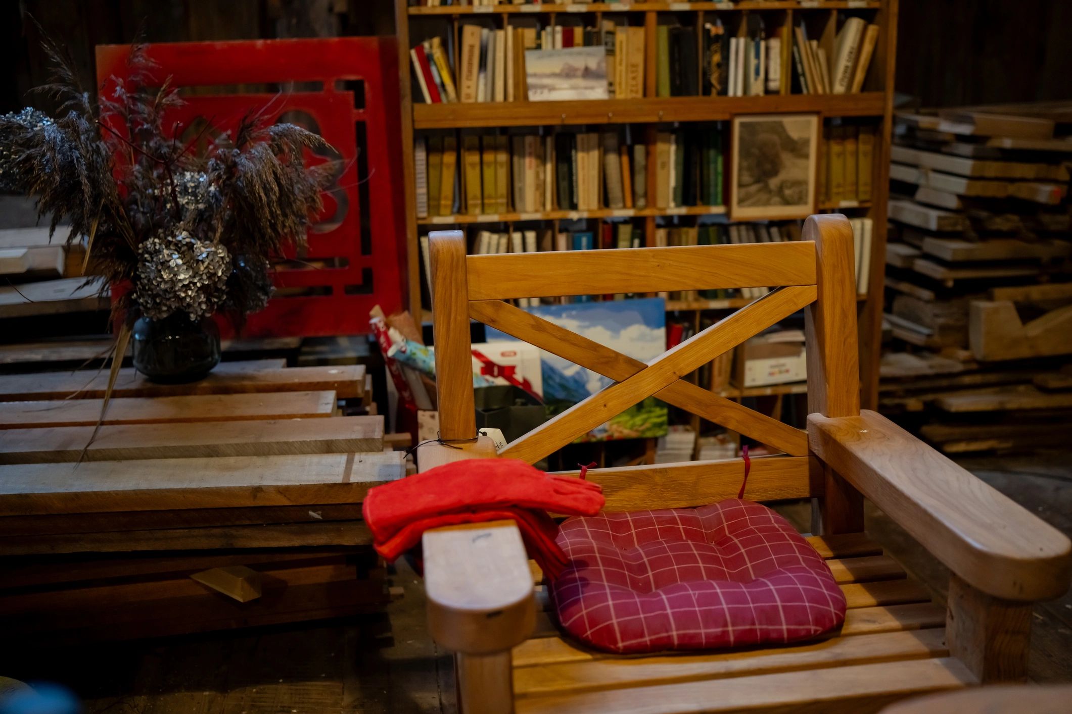 Stack of books next to pencils in a holder and a camera.