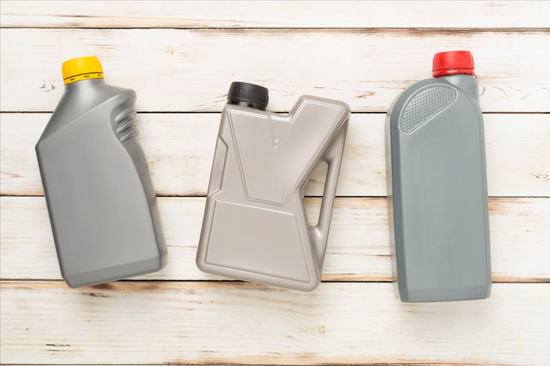 Automobile products and tools on wooden background, top view