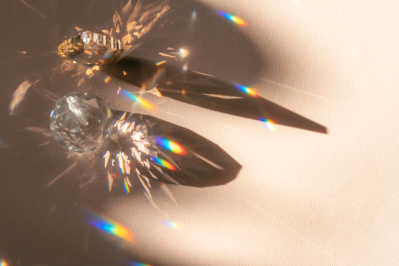 Abstract shadow from sun glare on glass, composition with a blank background for a product presentation. Beige background with iridescent highlights. Showcase Nude Studio Minimal.