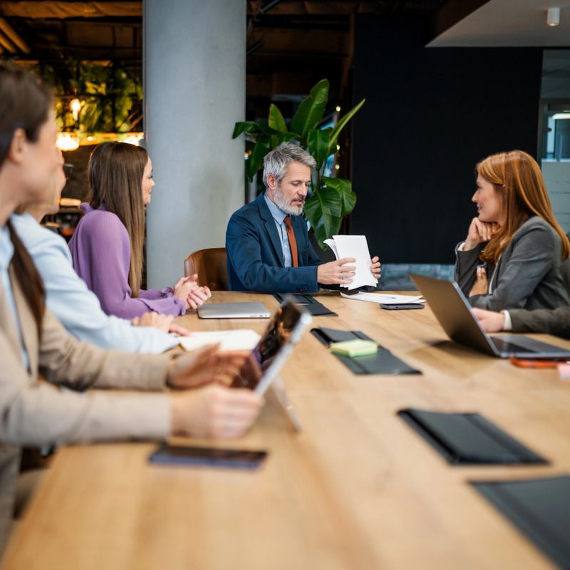 Business professionals discussing strategy and collaborating during a corporate meeting in a modern office environment