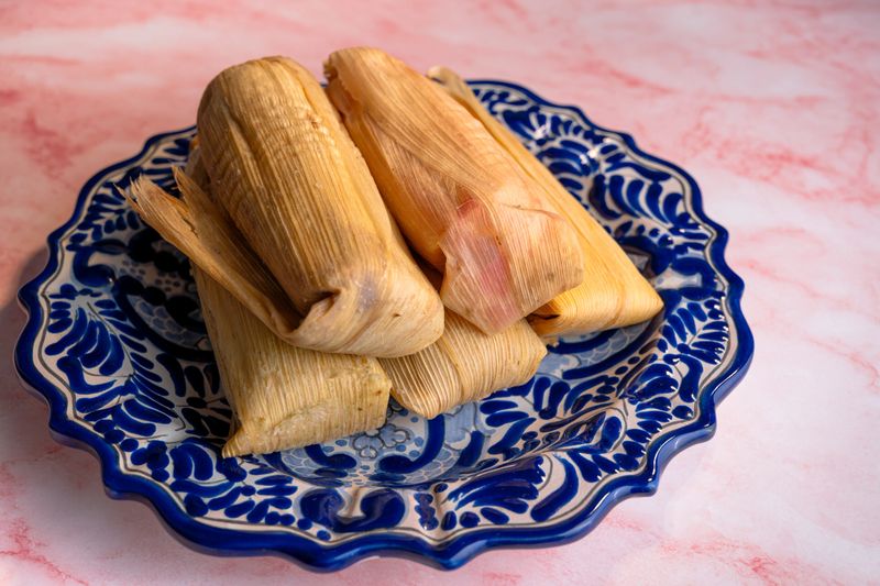 Top view of typical Mexican food, tamales in handcrafted tableware