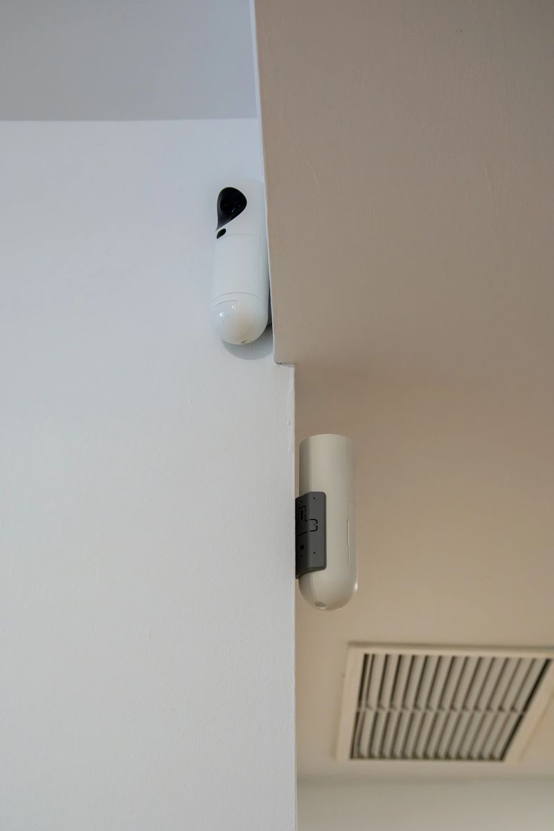 Surveillance cameras installed on an indoor wall as part of a home alarm system. Concept of home security, monitoring, safety, and residential protection technology.