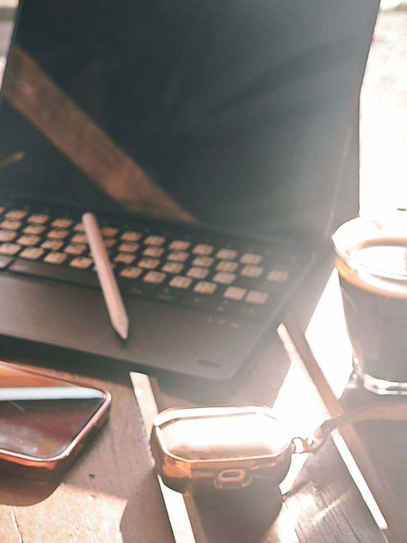 Coffee and Laptop in Warm Morning Light