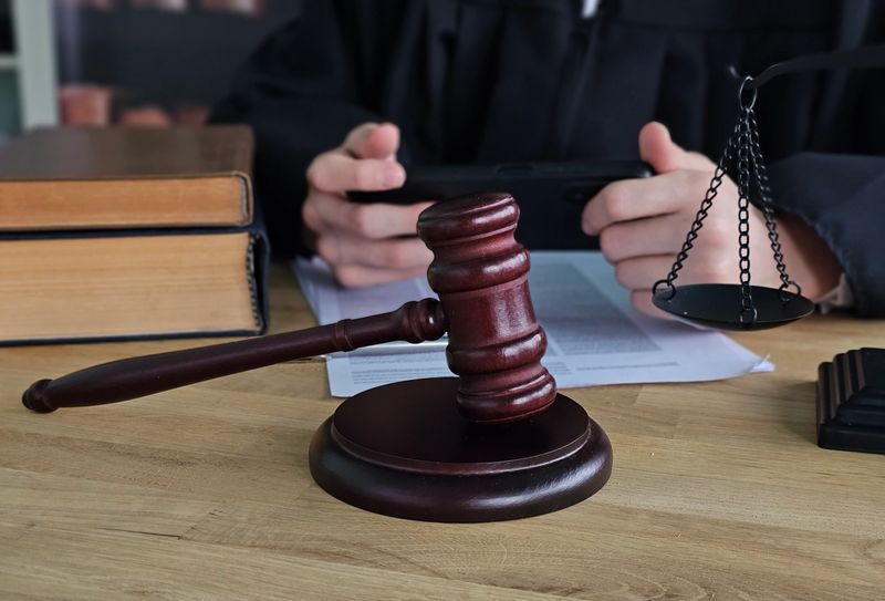 Courtroom setting with judge gavel and legal documents on table for upcoming trial