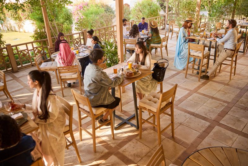 Multiple tables with people dining and having lunch at a restaurant.