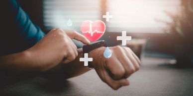 Person using a smartwatch with health icons.