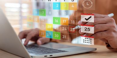 Person using digital calendar on laptop.