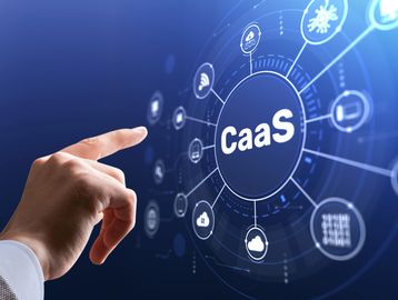 A hand interacts with a futuristic digital interface displaying 'CaaS' and tech icons.