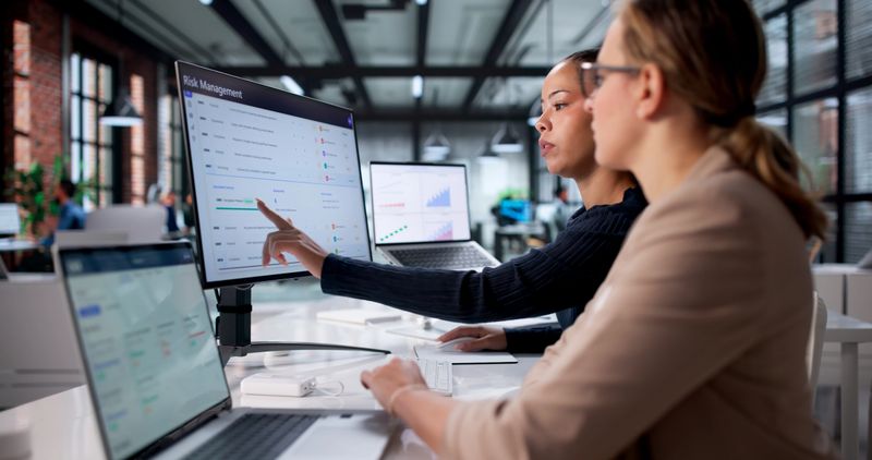 Analyzing Market Data On Corporate Software, Female Analyst Looking For Strategic Solutions.