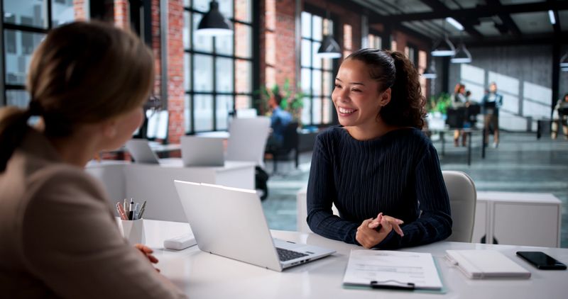 Consulting On Investments: Hispanic Financial Planner Meeting With Young Woman