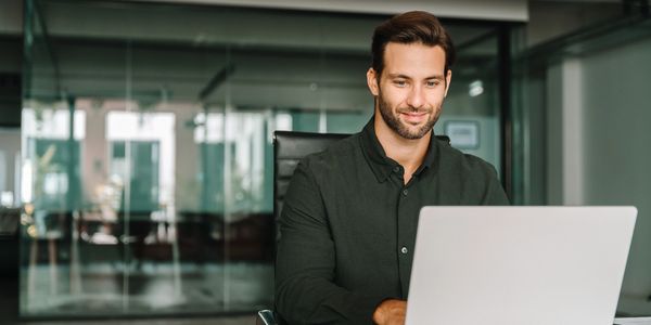 Man working on laptop in office.
