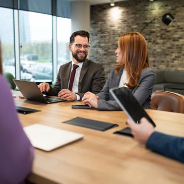 Two business professionals engaged in a meeting at a conference table.