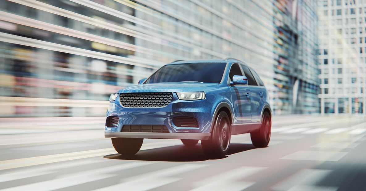 Blue SUV driving fast through city streets.