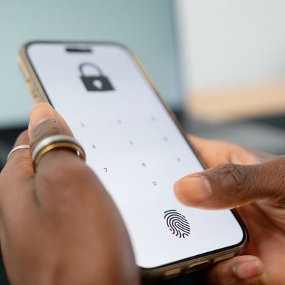 Person unlocking phone using fingerprint authentication.