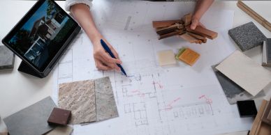 Architect reviewing building plans with materials.