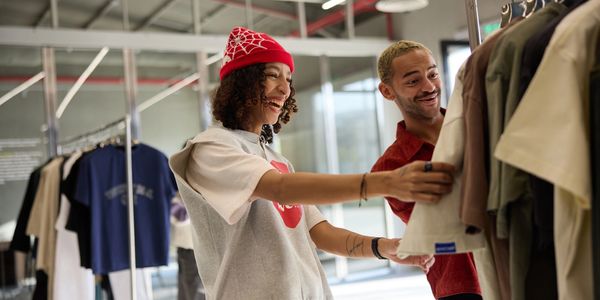 Two friends shopping and smiling.