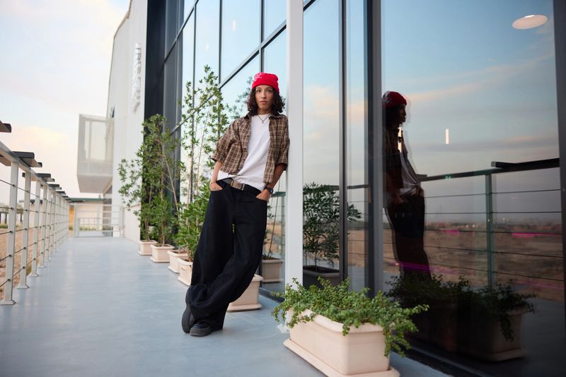 Stylish model showcasing the latest fashion trends at a urban rooftop setting.